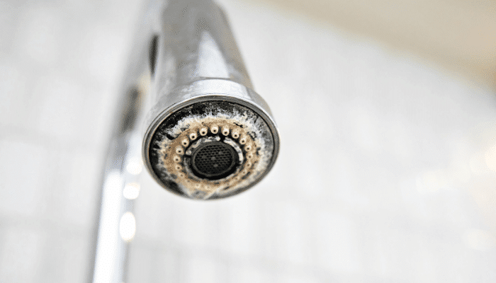 Tight Close Up Of Chalky White Limescale Crusted On A Real Faucet