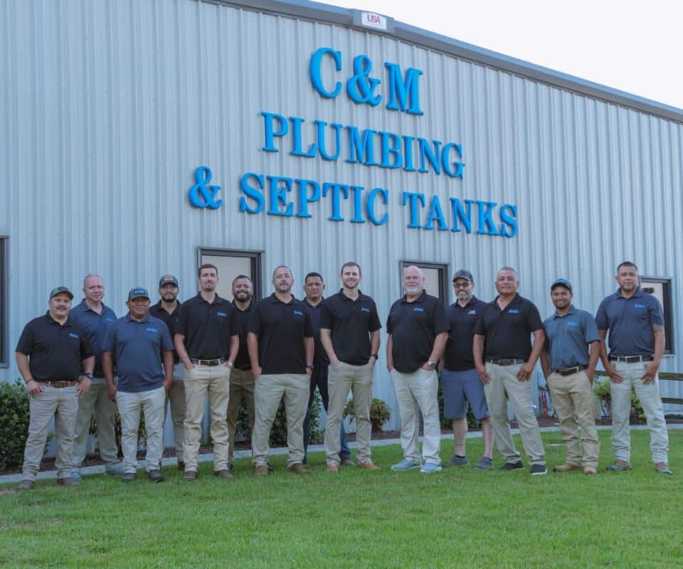 cm-group-photo-infront-of-building-with-logo