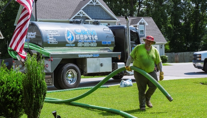 Septic Truck And Worker Pumping Tank Septic Truck And Worker Pumping Tank